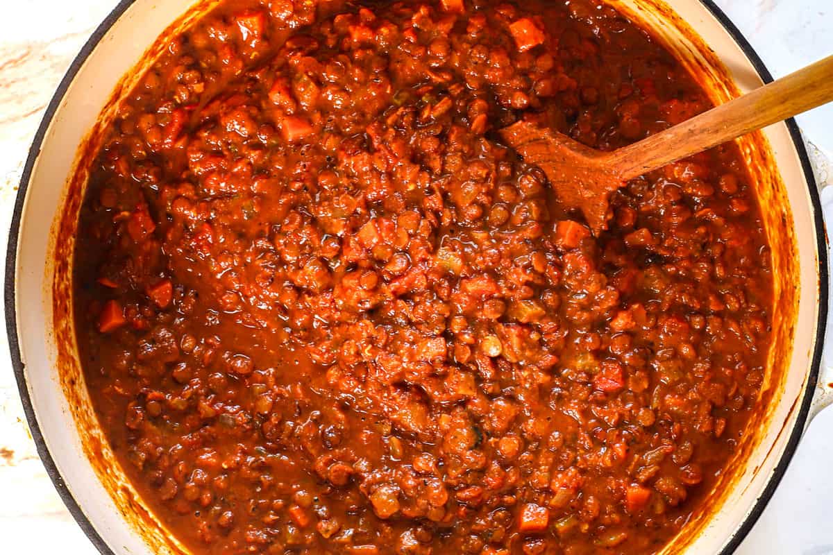 showing how to make lentil soup by simmering the soup until thickened