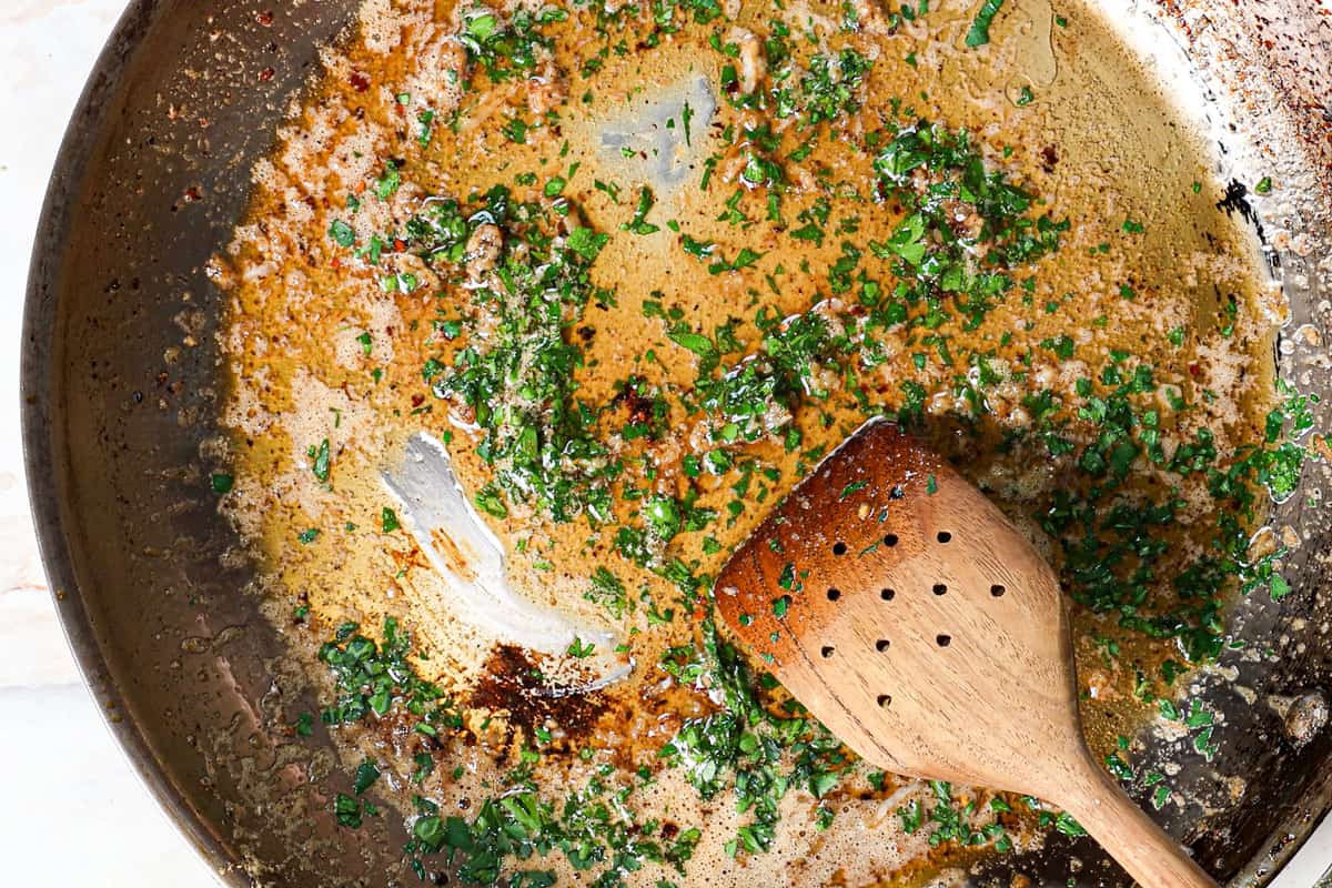 showing how to make pan seared scallops by making lemon garlic butter sauce by sautรฉing garlic, then adding lemon and parsley