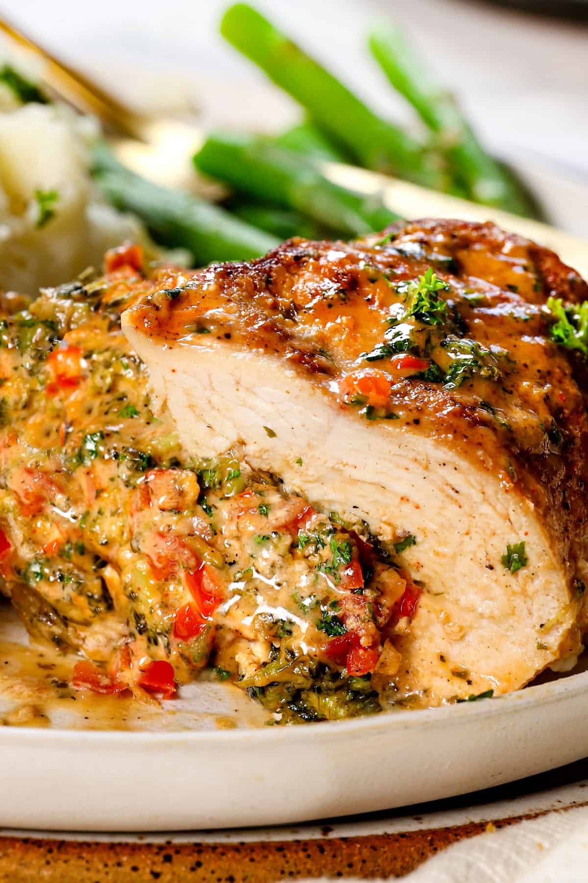 stuffed chicken breast with broccoli and cheese cut in half showing the cheesy broccoli filling