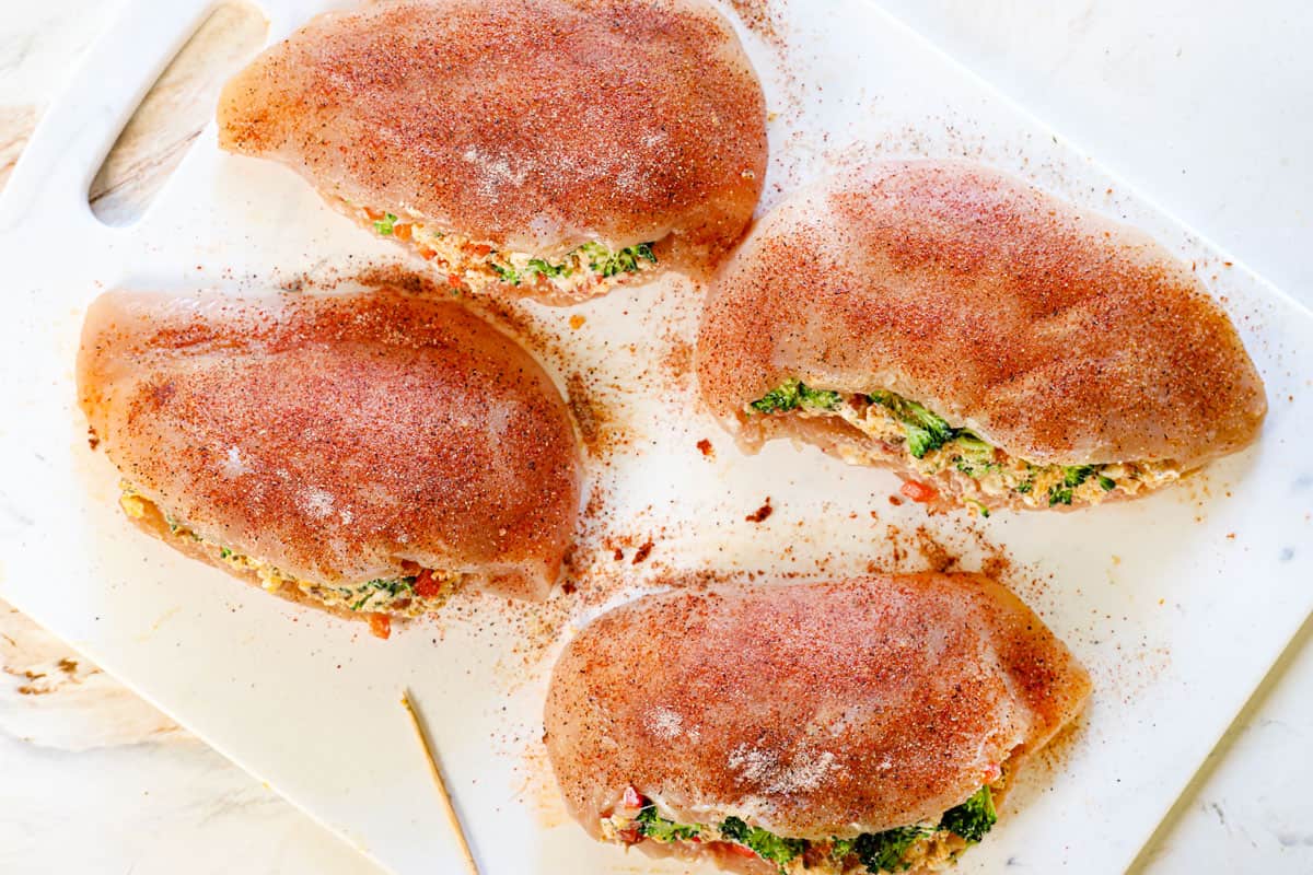showing how to make stuffed chicken by seasoning with garlic powder, onion powder, paprika, salt and pepper