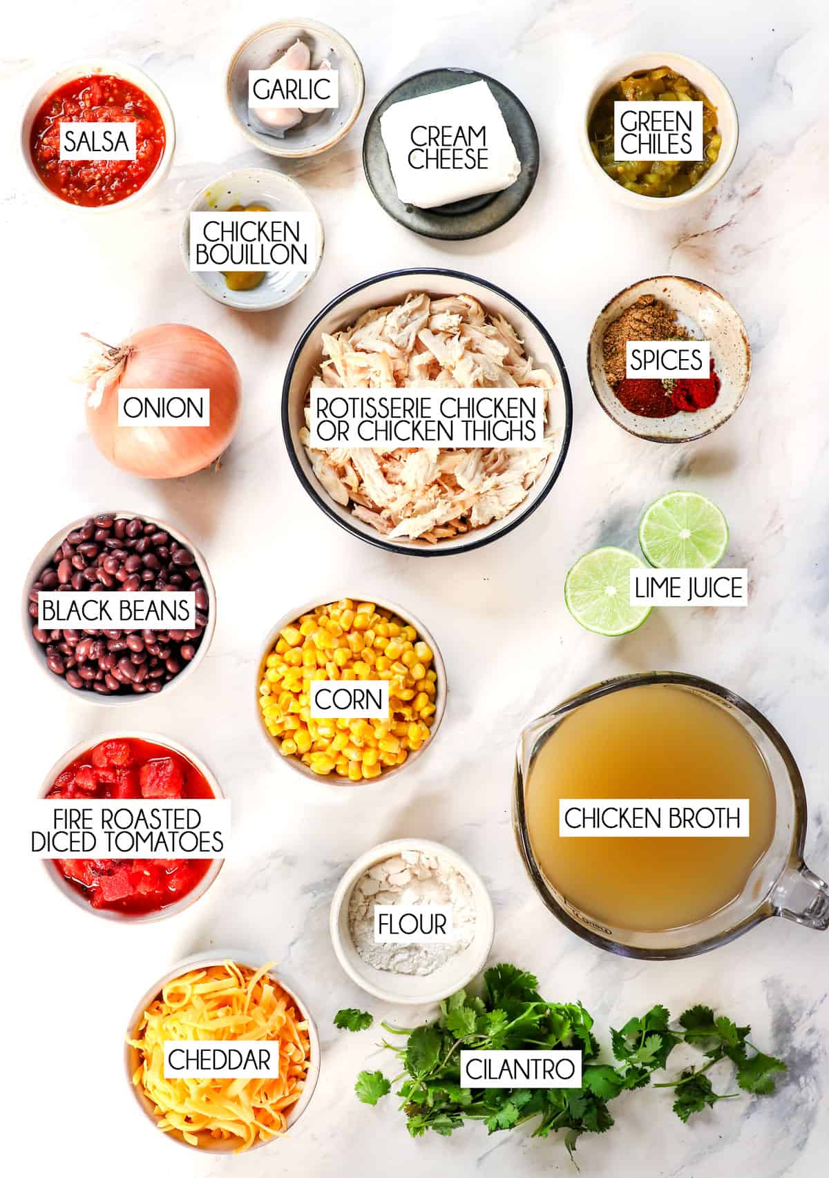 top view showing ingredients for slow cooker chicken taco soup: chicken, black beans, corn, diced tomatoes, onion, chicken broth, spices, garlic, cream cheese