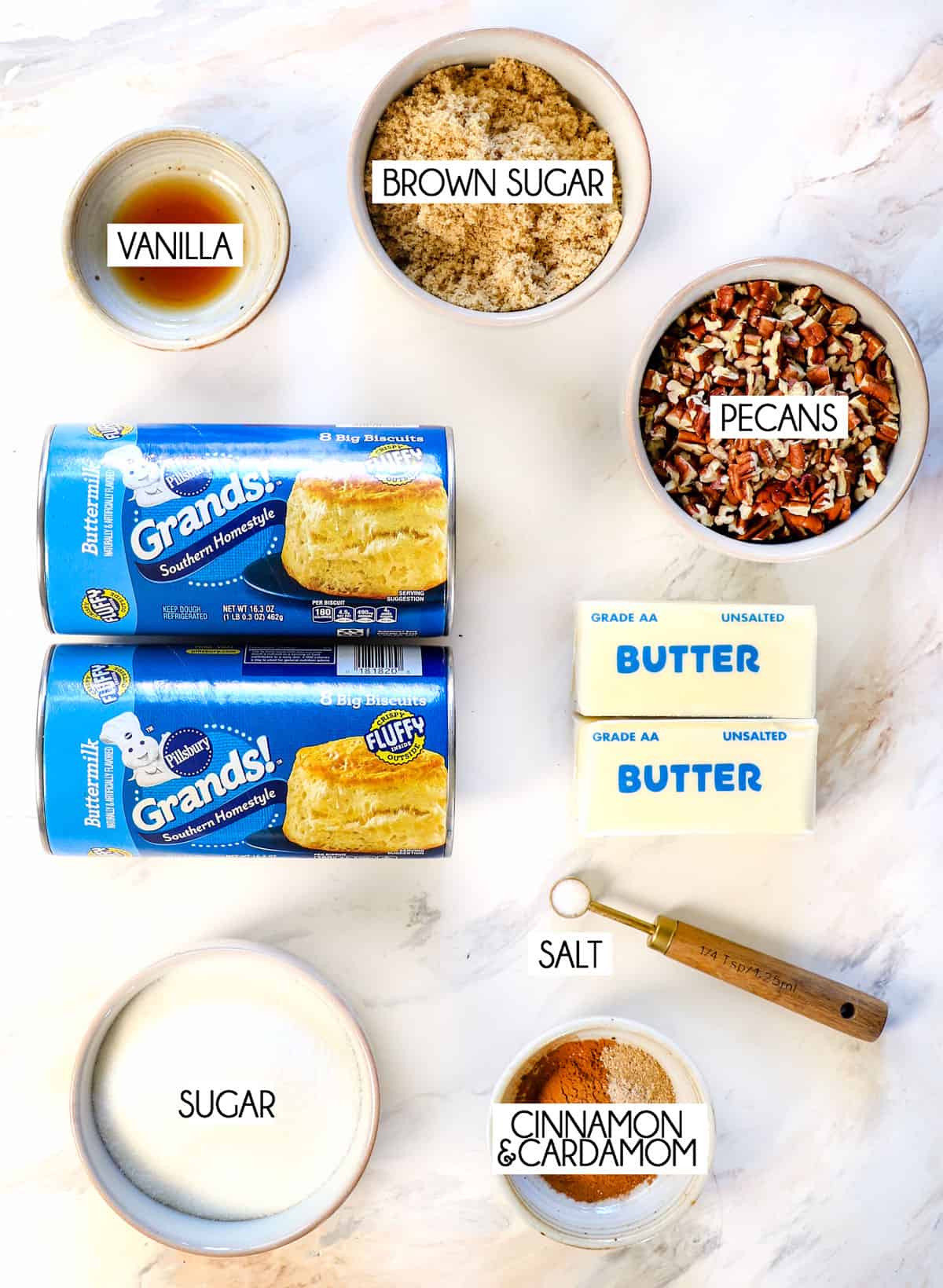 top view of Monkey Bread Ingredients: Pillsbury Grands biscuits, cinnamon, sugar, brown sugar, butter, vanilla extract, pecans