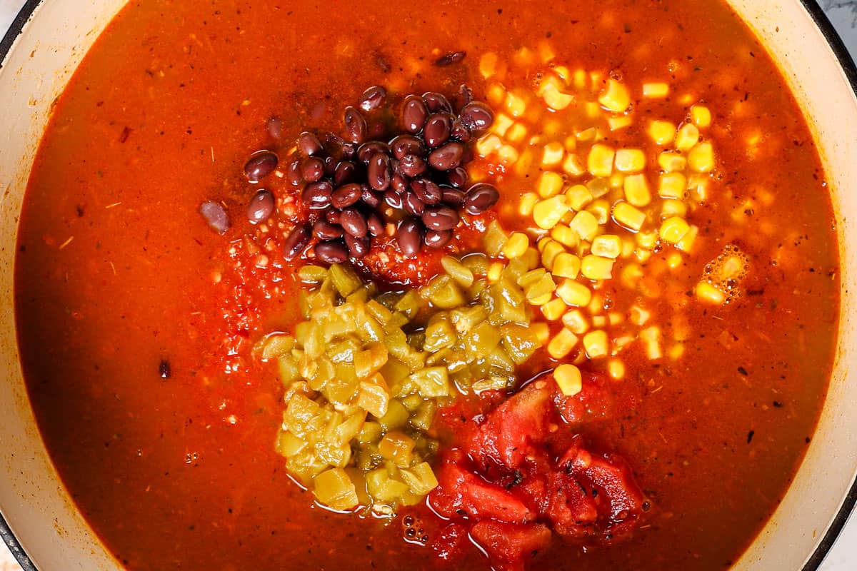 showing how to make chicken taco soup recipe byย returning the chicken to the pot, followed by the chicken broth, black beans, corn, diced tomatoes, green chiles, and bouillon.