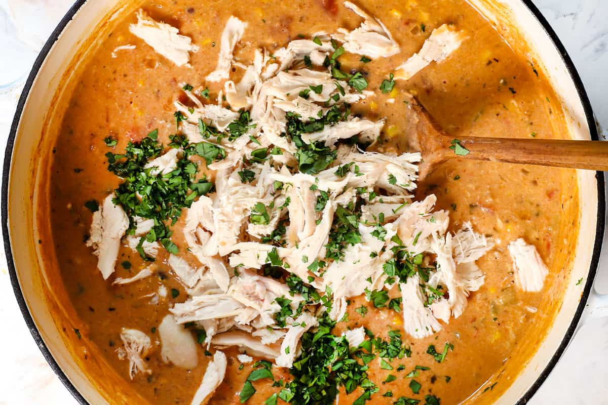 showing how to make chicken taco soup by stirring in cilantro and lime juice