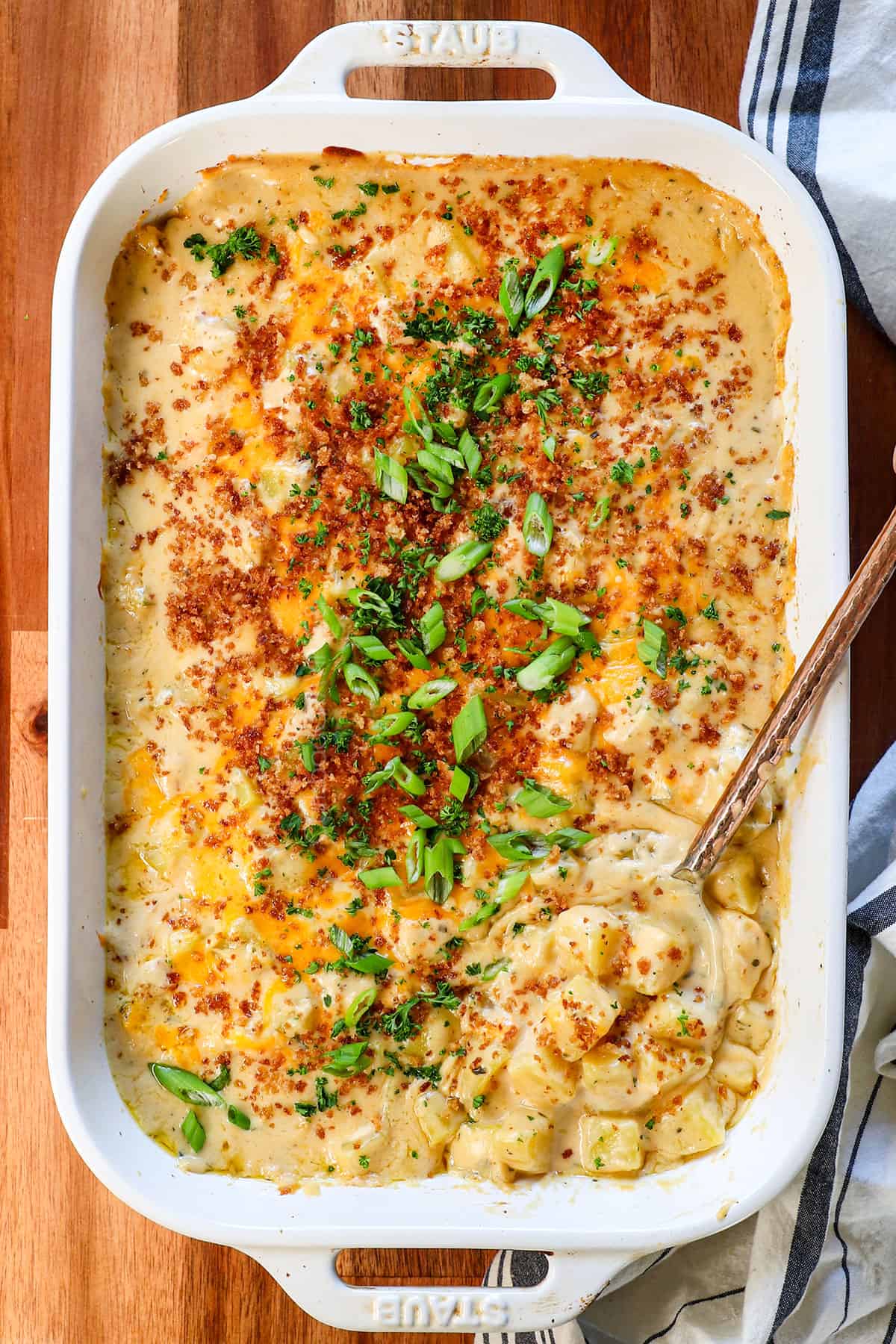 showing how to make cheesy potatoes by topping the casserole with crispy panko after baking