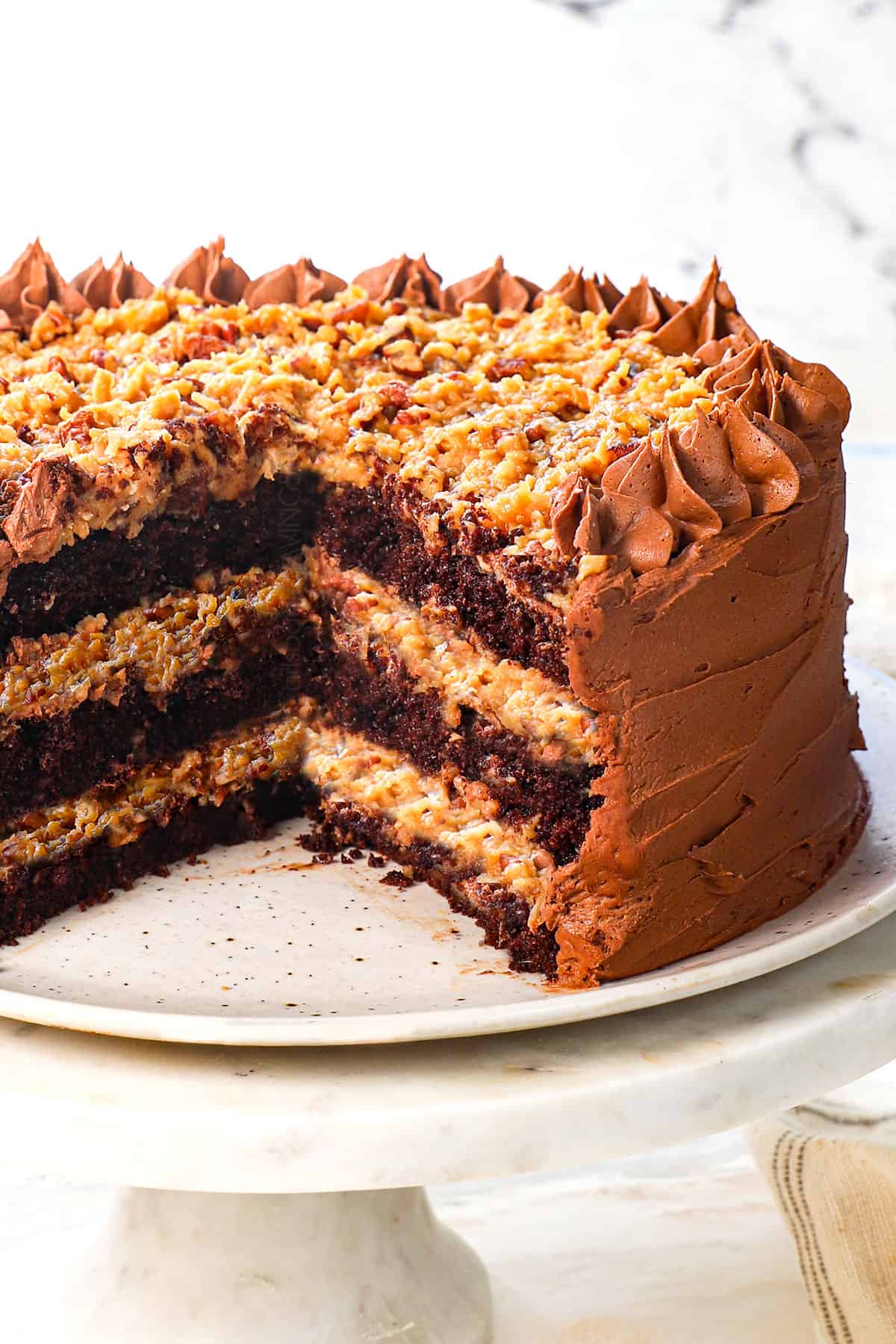 chocolate german cake on a platter with German Chocolate Frosting