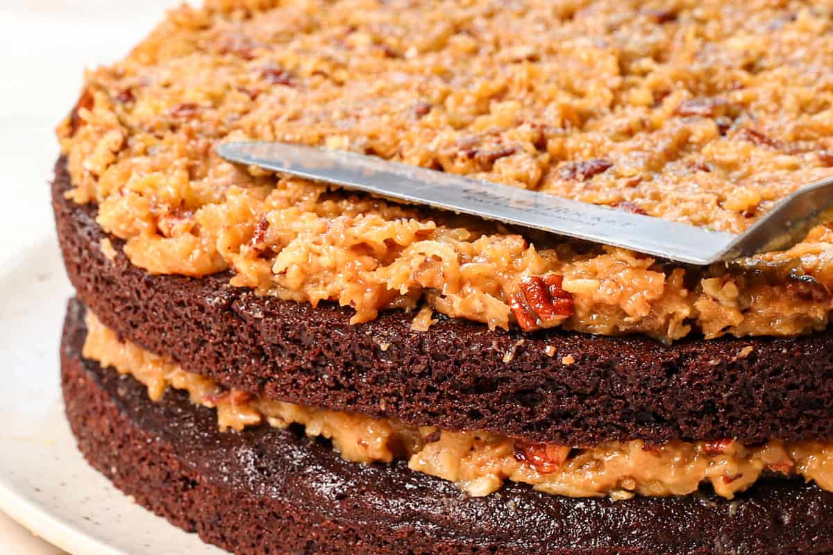 showing how to make German Chocolate Cake by frosting the layers with buttercream frosting, then German Chocolate Cake Frosting