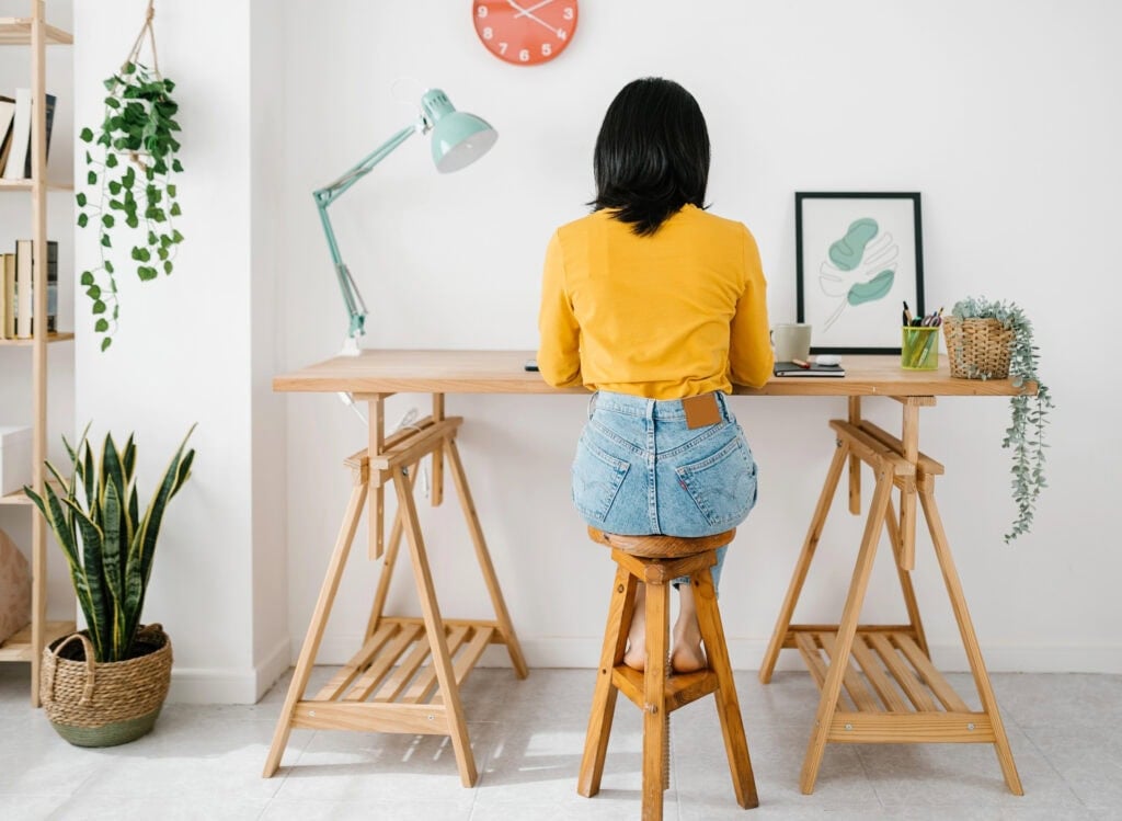 woman working at desk - How to make $3000 a month from home