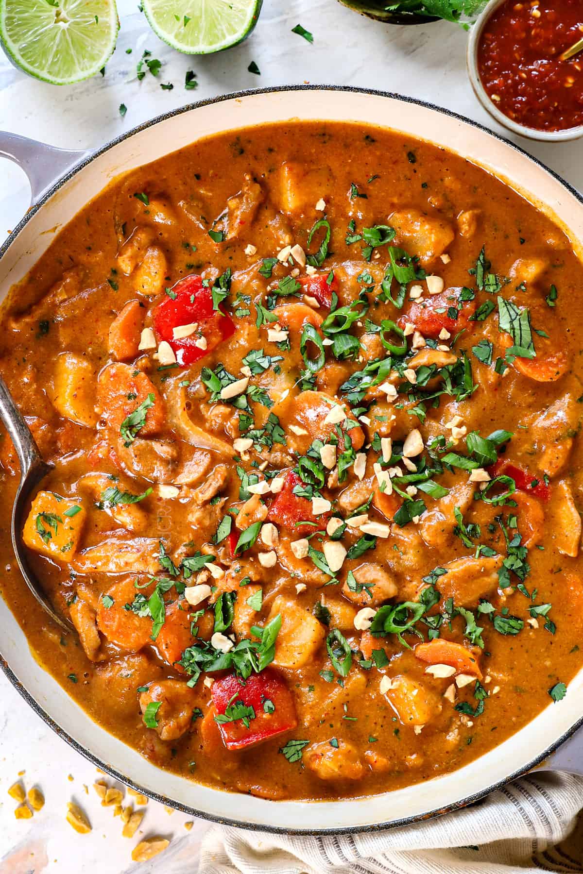 top view showing how to make massaman curry by garnishing with peanuts