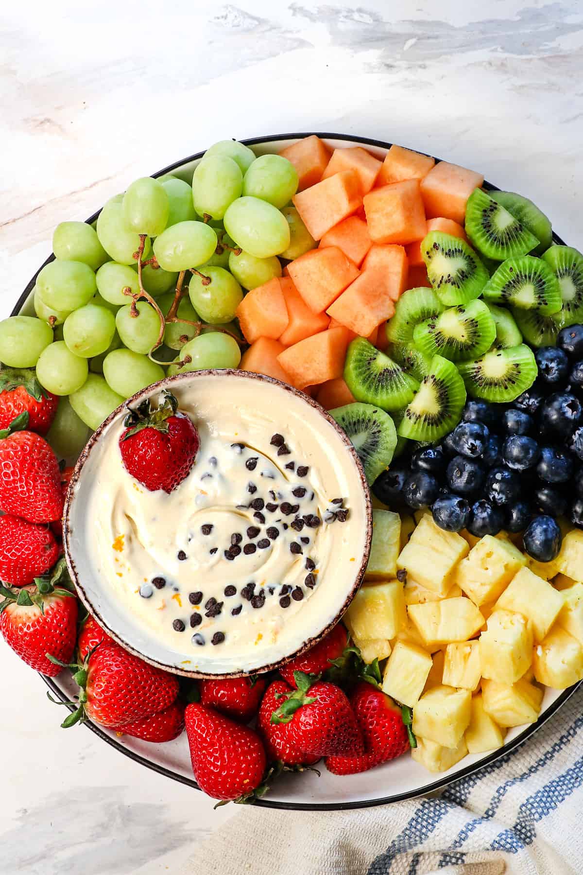 top view of fruit dip recipe served on a platter with a variety of fruits