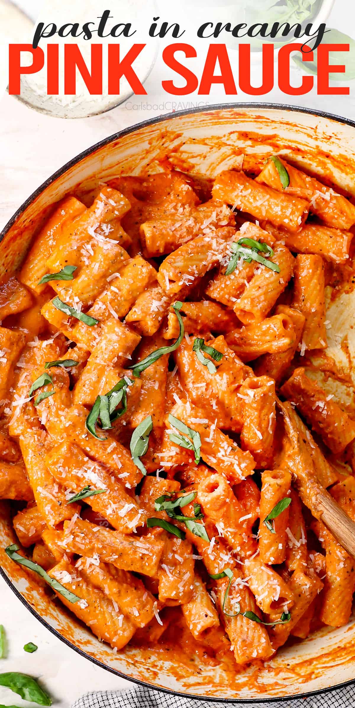 showing how to serve pink sauce by combining with pasta in a large pan
