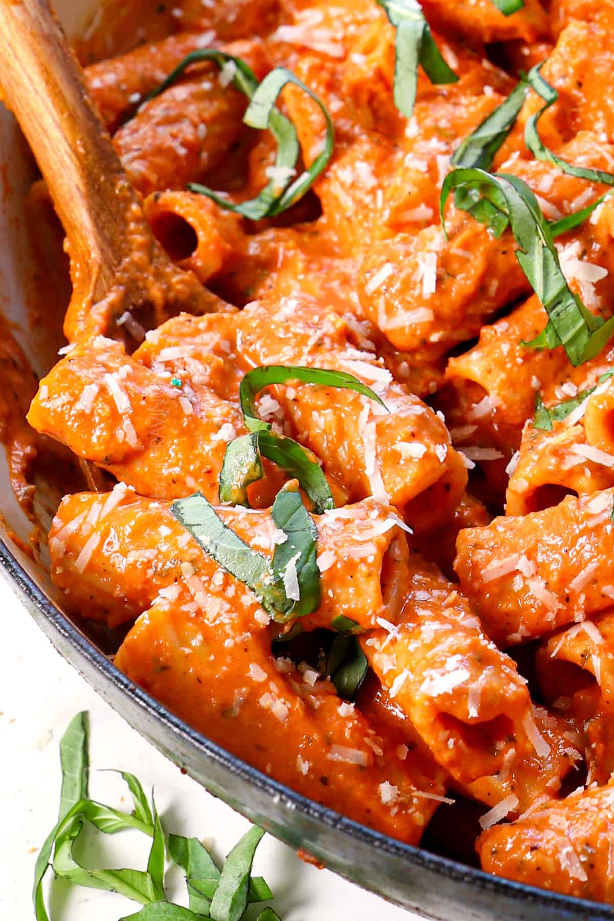 up close of scooping up pink sauce pasta showing how creamy and velvety it is