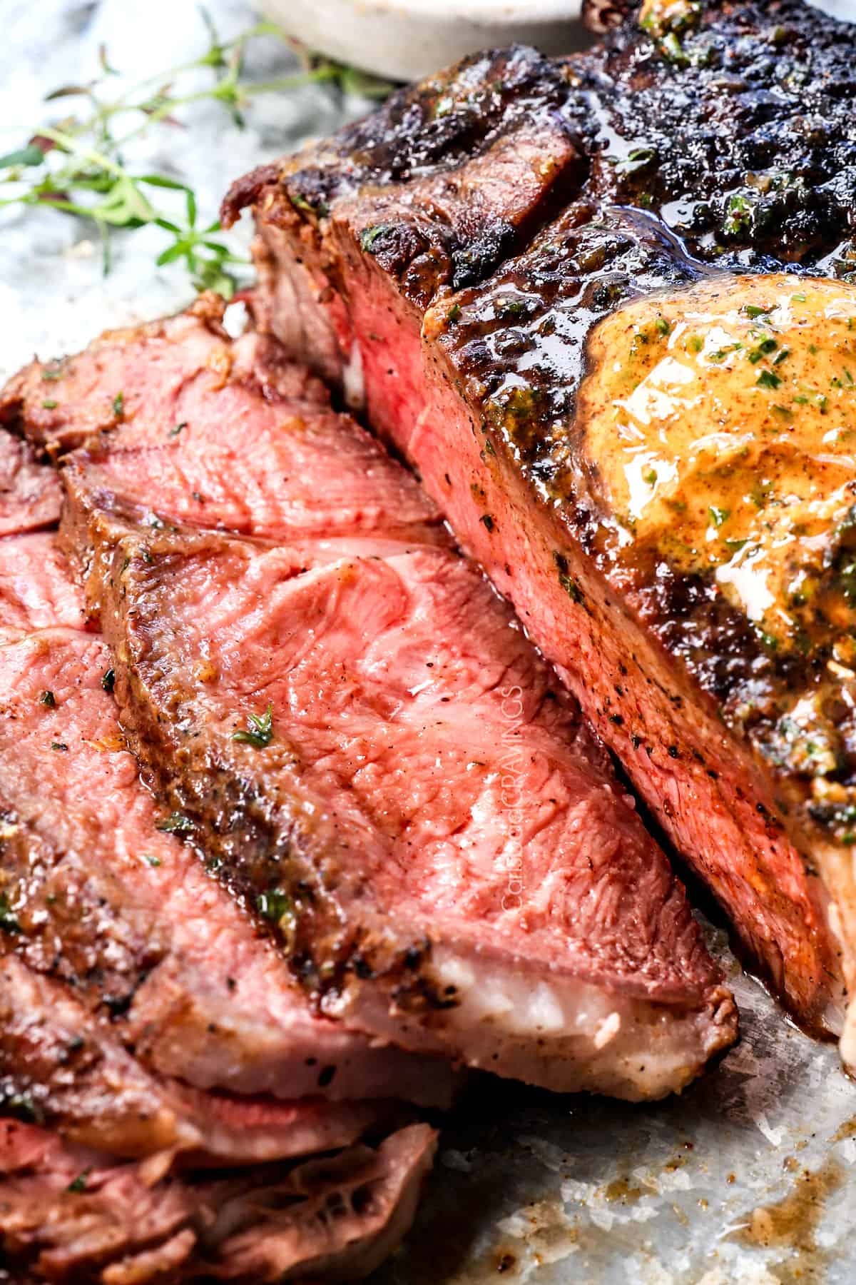 up close of sliced tomahawk ribeye showing how juicy it is