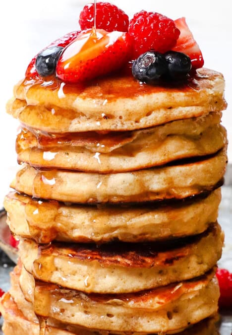 showing how to serve fluffy pancakes by drizzling with syrup