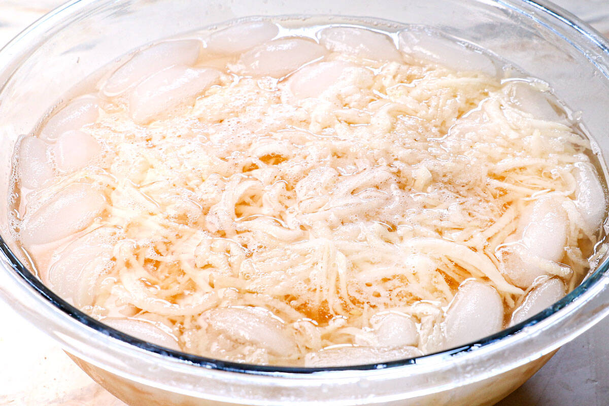 showing how to make hash browns by soaking the shredded potatoes in water
