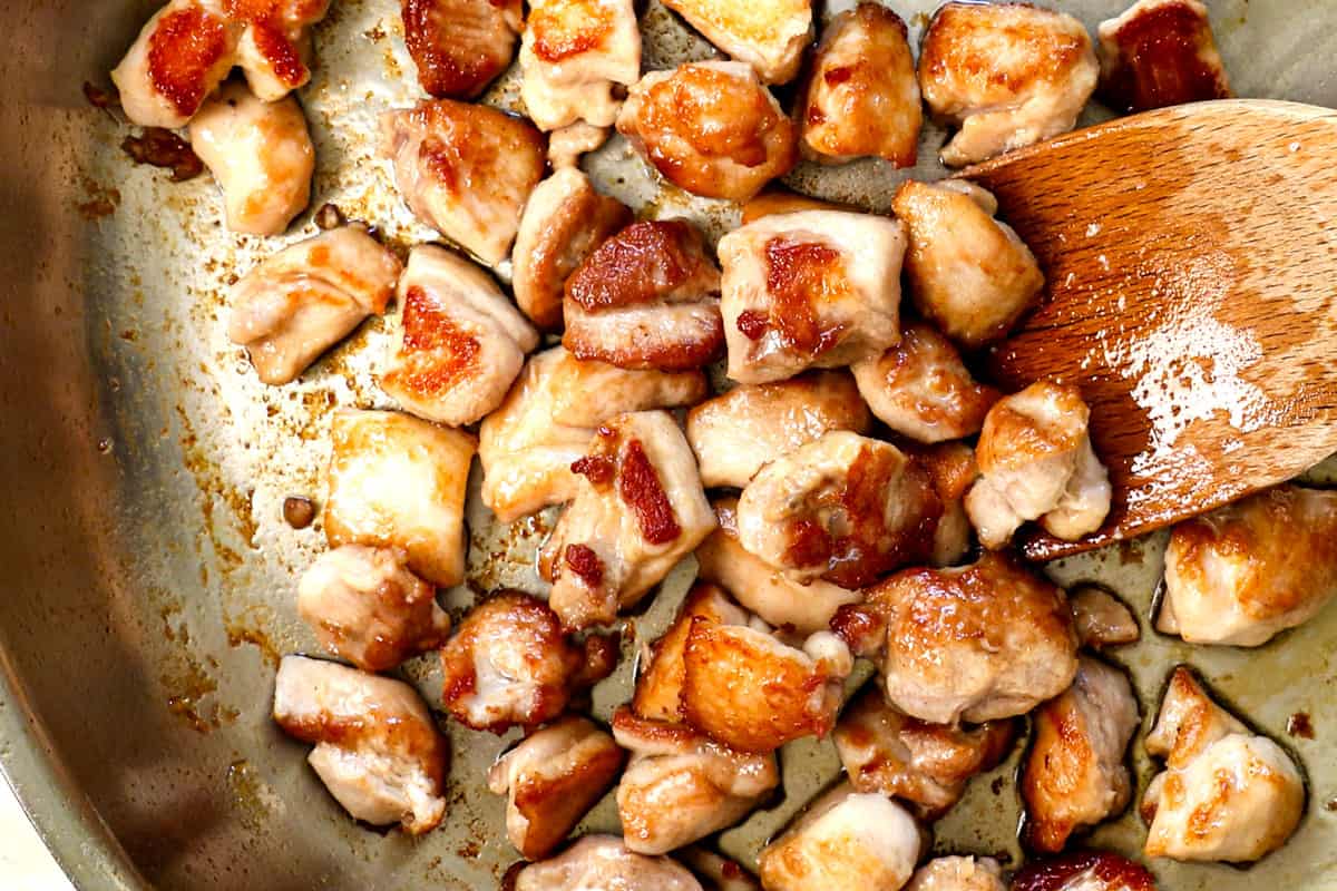 showing how to make lo mein noodles recipe by stir frying the chicken until golden and seared