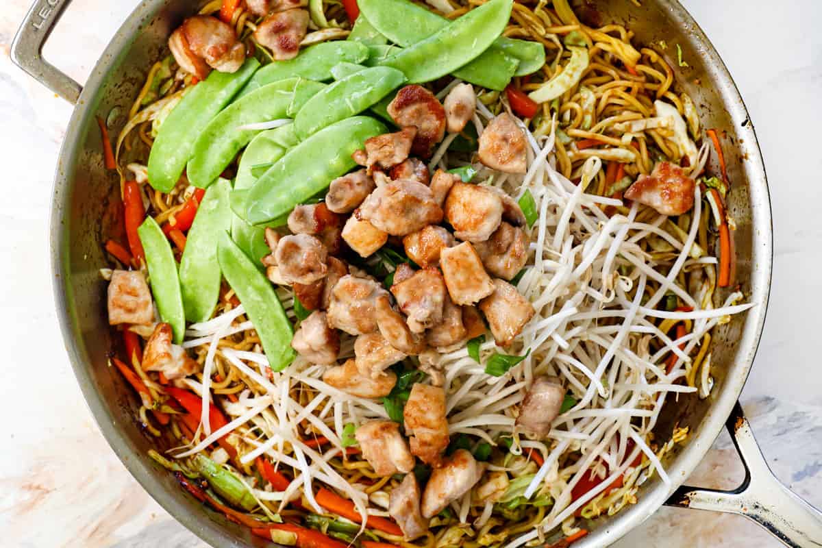 showing how to make lo mein by adding the chicken and sprouts and tossing to combine