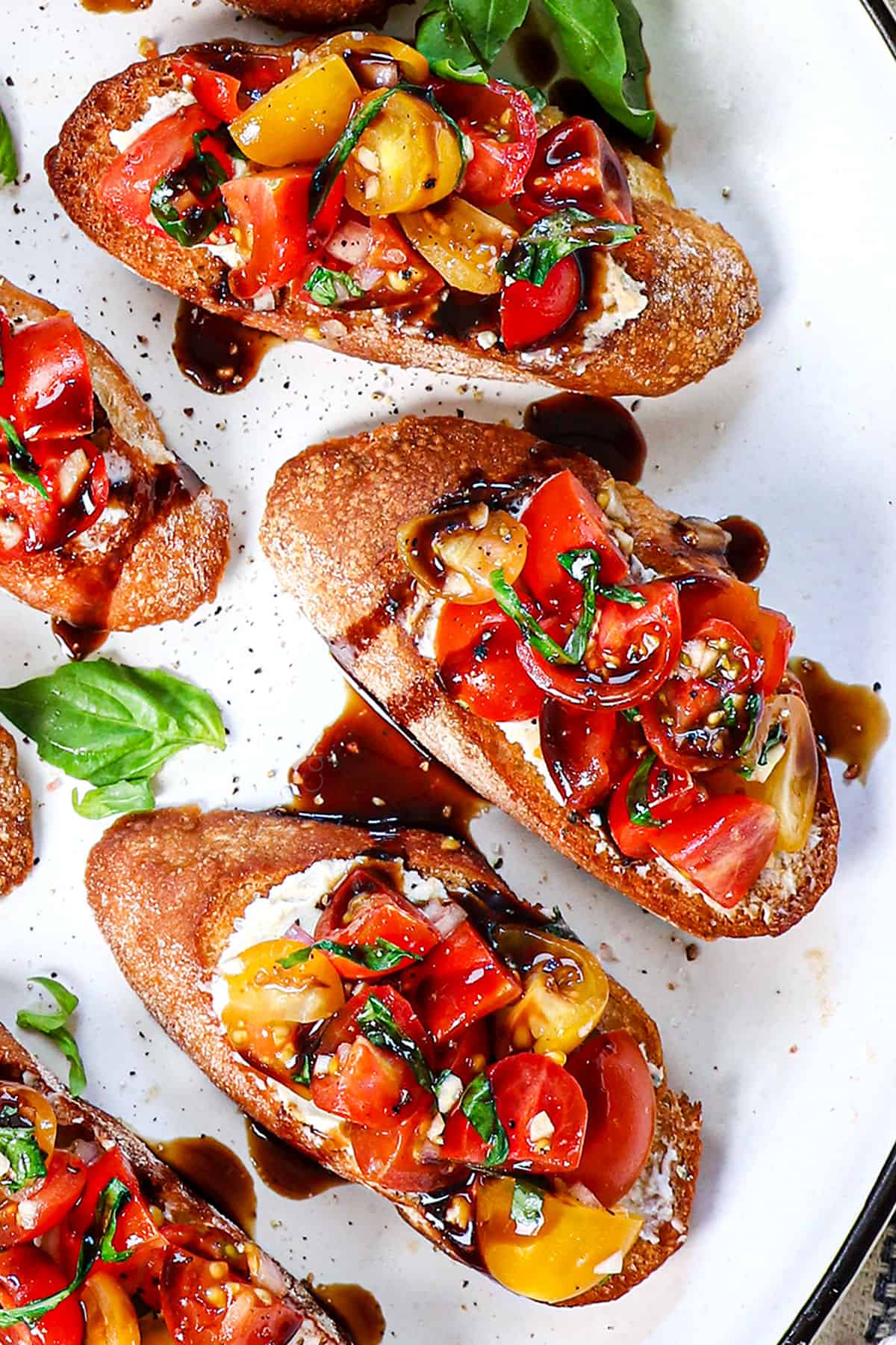 up close of recipe for bruschetta showing how to serve topped with freshly cracked salt and pepper