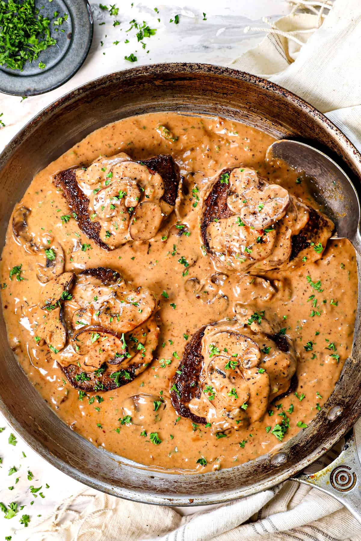 top view of Steak Diane Cheesecake Factory in skillet showing how creamy the sauce is