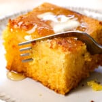 up close of a fork taking a bite out of homemade cornbread, showing how moist it is
