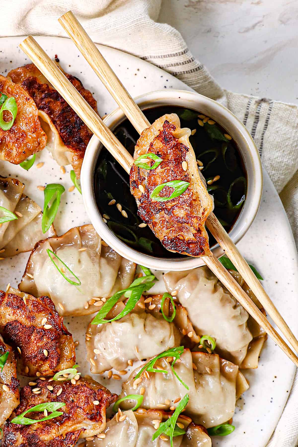 homemade gyoza being eaten with chopsticks