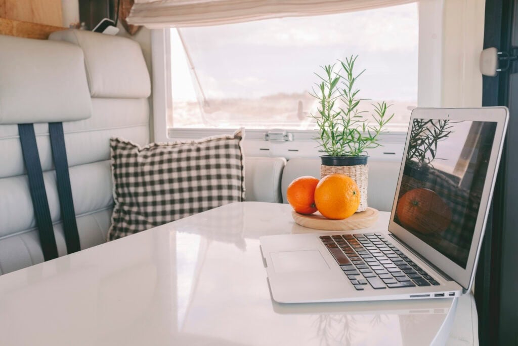 laptop on table in RV for article how to make $4,000 a month