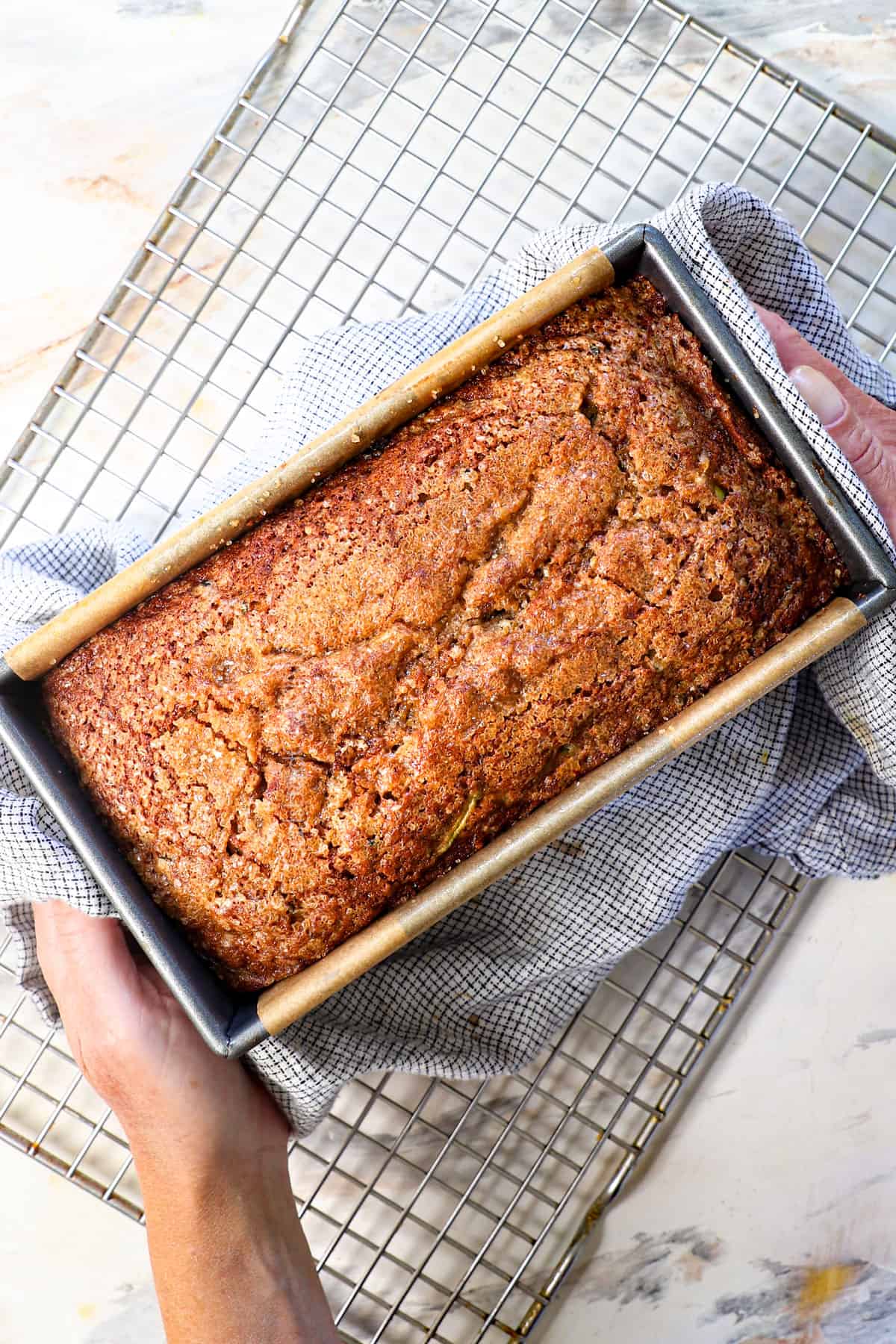 showing how to make zucchini bread by baking until a toothpick comes out clear
