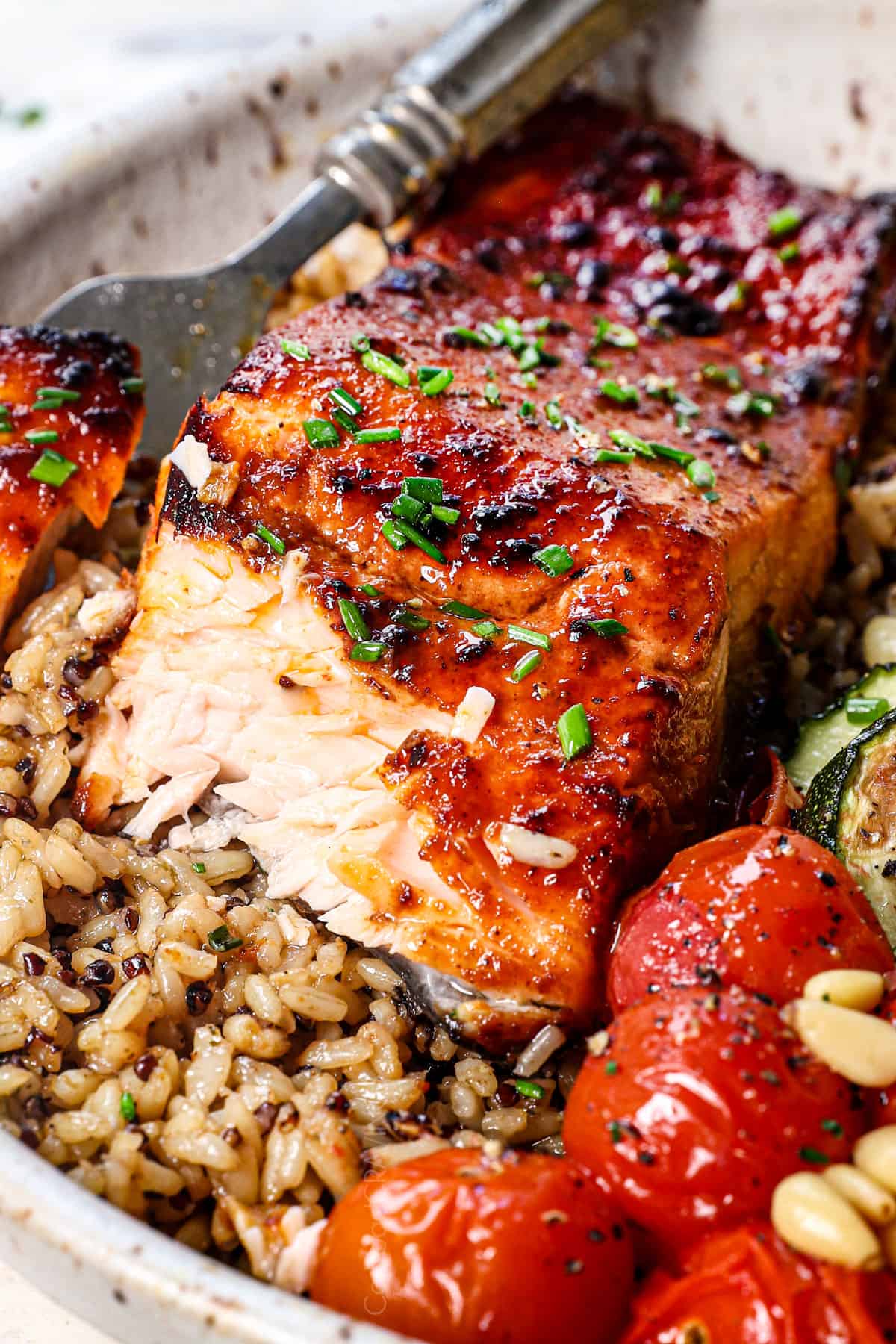 up close of air fried salmon with a bite taken out showing how juicy the interior is