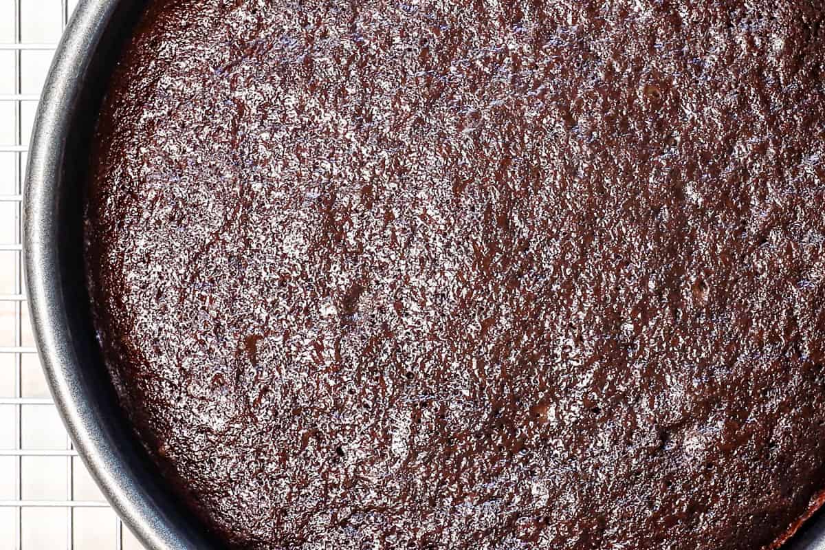 showing how to make ice cream cake by baking the cakes, then cooling completely before layering with ice cream