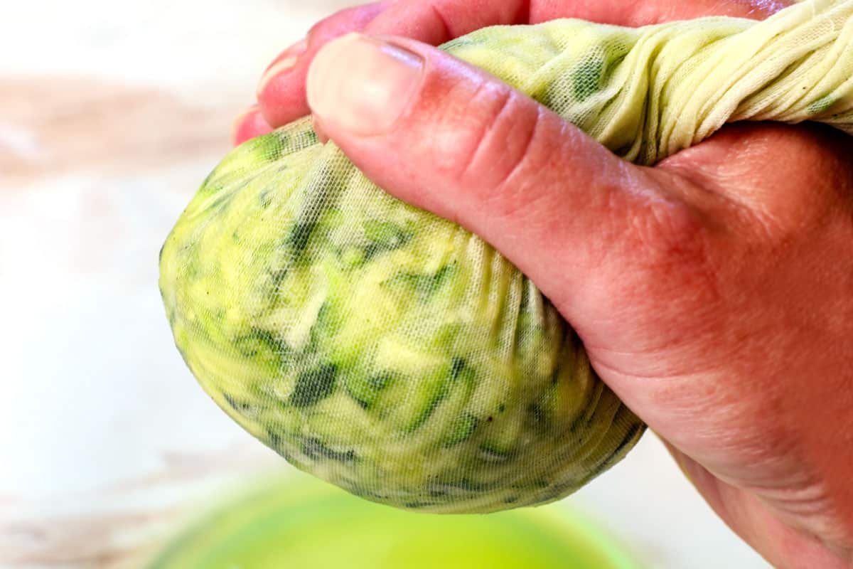 showing how to make zucchini fritters by squeezing the zucchini dry in a cheesecloth