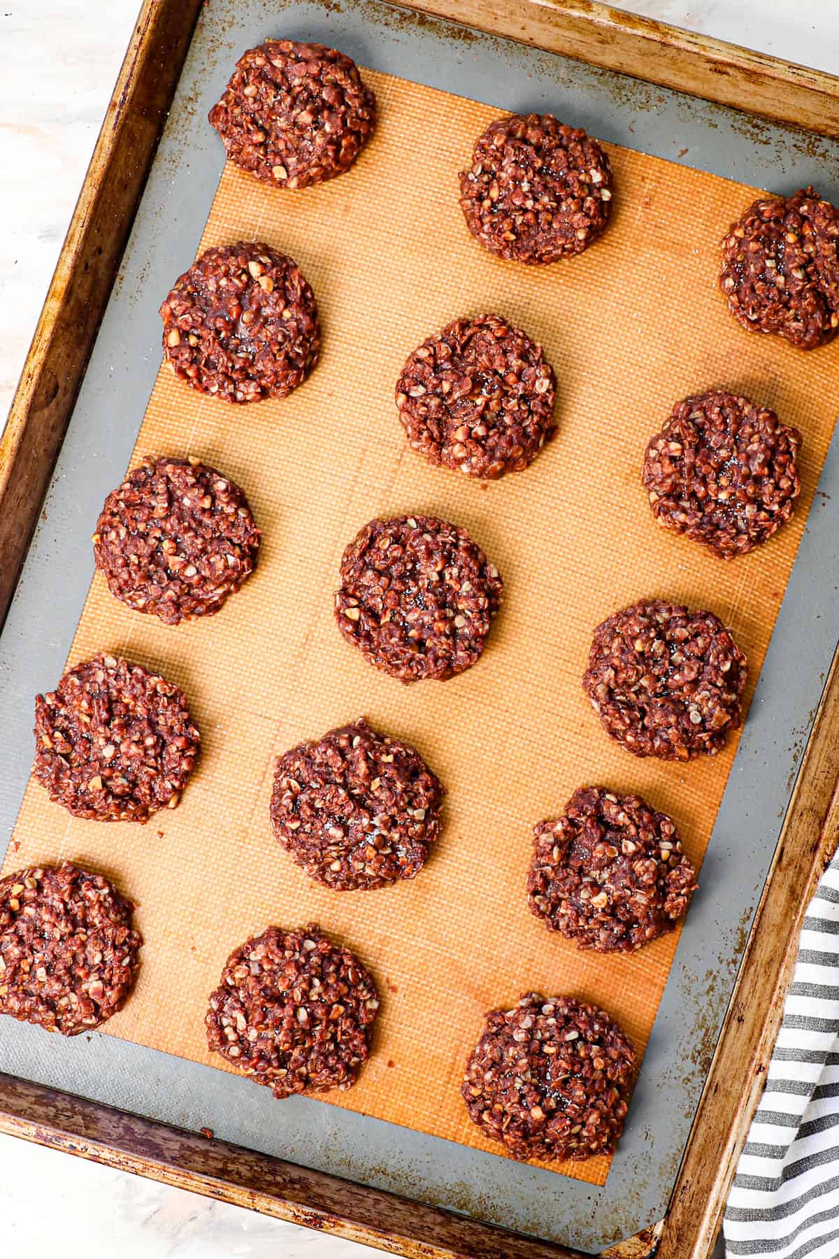 showing how to make no bake cookies by letting the cookies set on a baking sheet