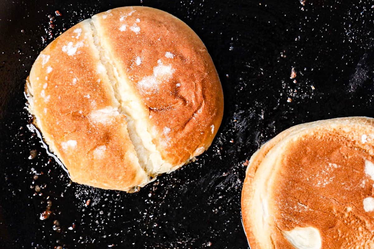 showing how to make smash burgers by toasting the buns cut side down in a skillet
