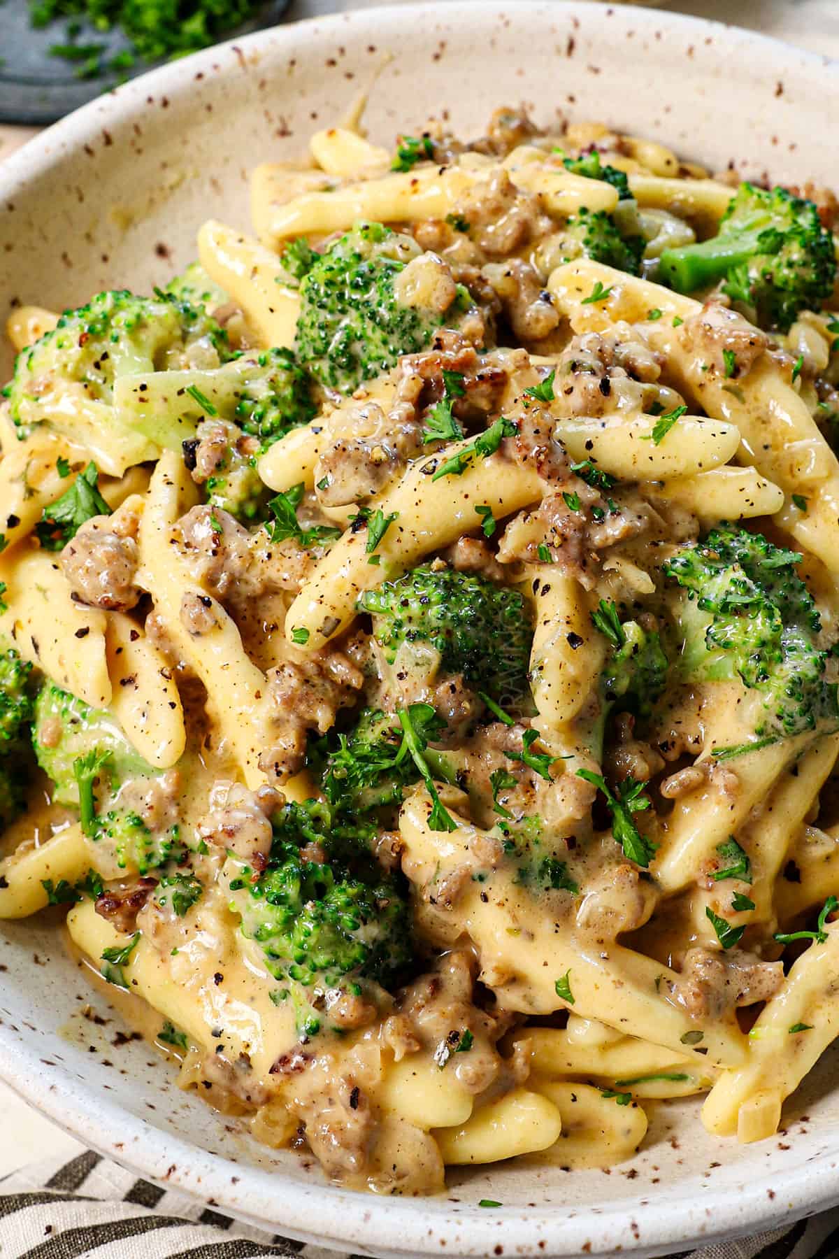 cavatelli and broccoli recipe being served in a dish with fresh parsley