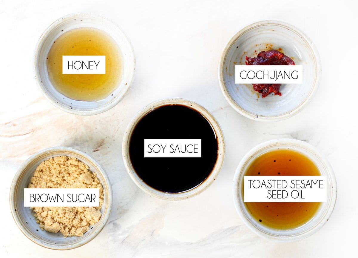 top view of japchae ingredients for the sauce: soy sauce, brown sugar, honey, toasted sesame seed oil