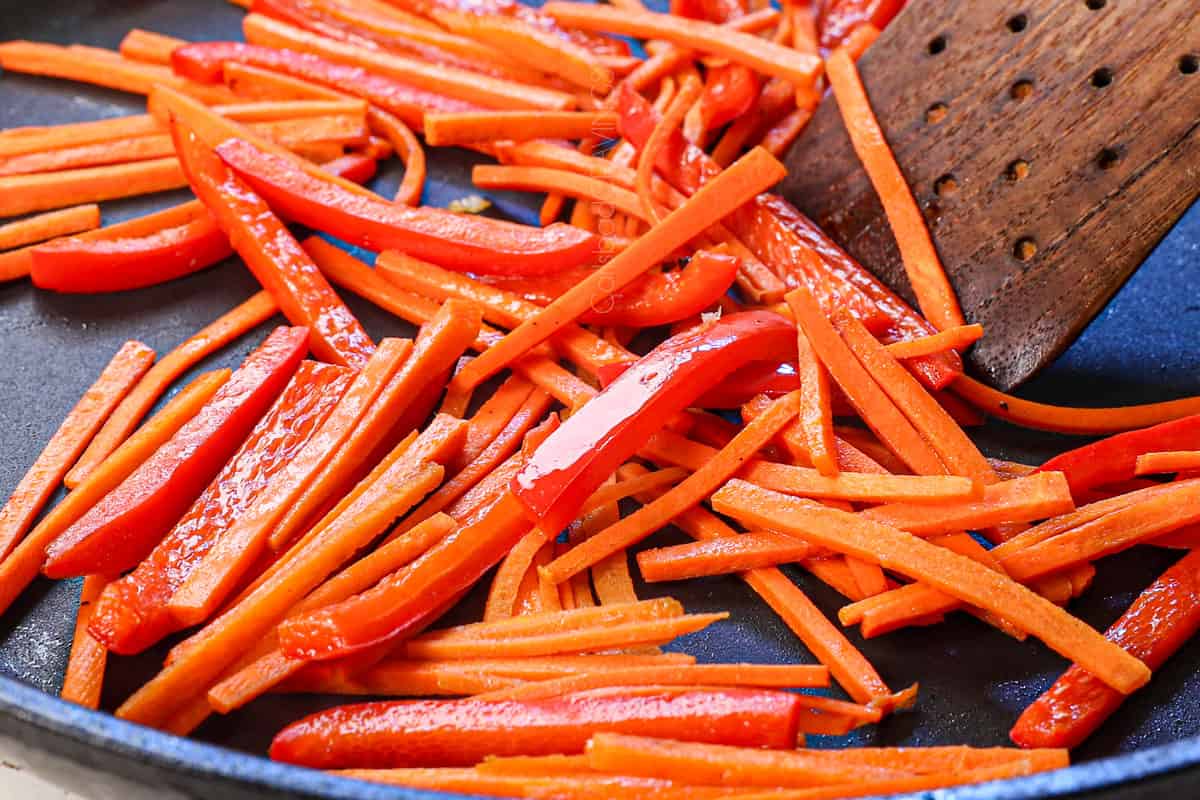 showing how to make japchae cooking the bell peppers and carrots together