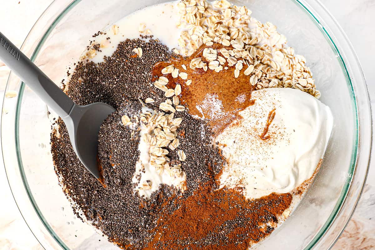 showing how to make overnight oats by adding rolled oats, milk, yogurt, chia seeds, ground cinnamon to a bowl
