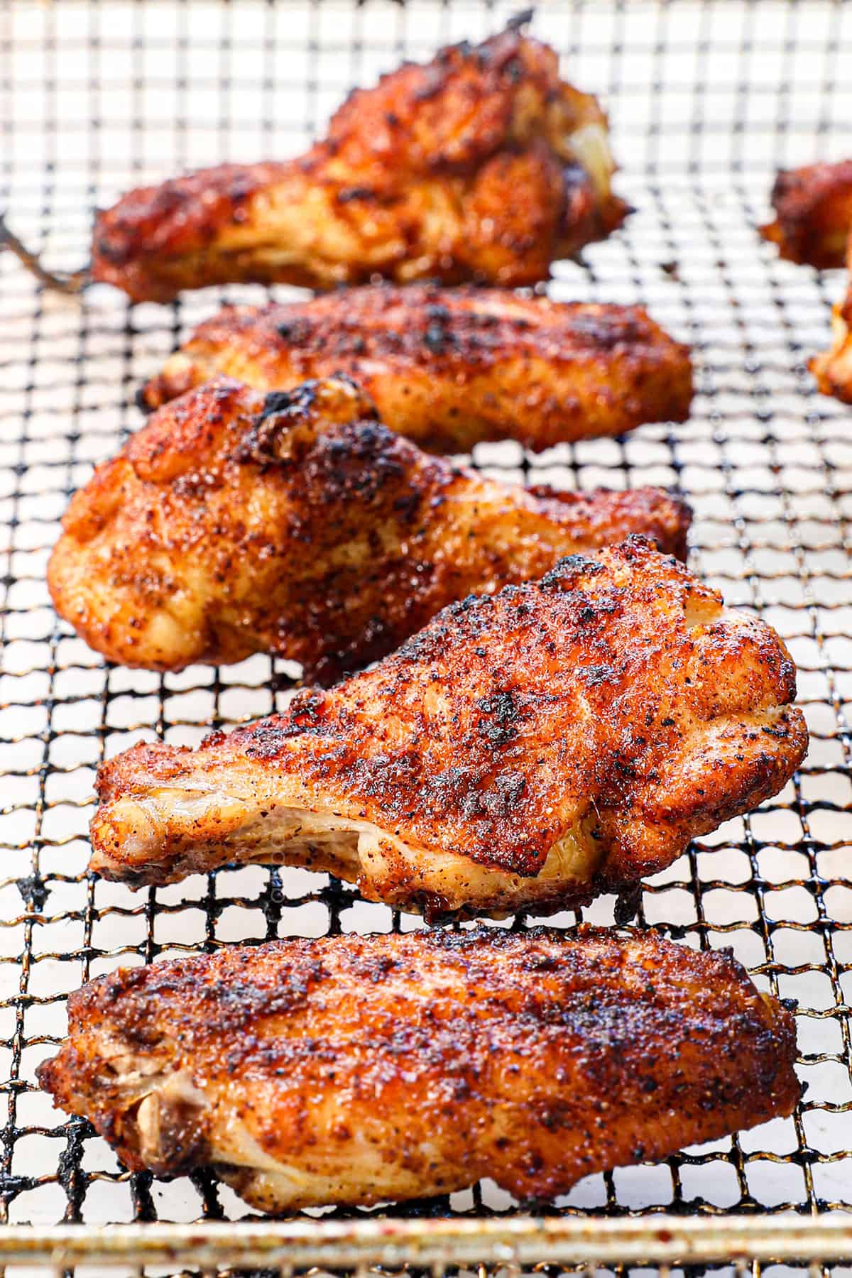 showing how to air fry chicken wings by air frying until crispy