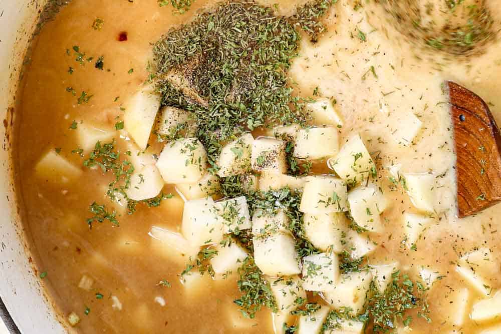 Showing how to make baked potato soup by adding potatoes, spices, chicken broth, milk