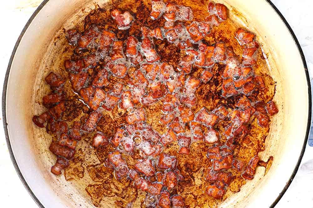 Showing how to make baked potato soup by cooking the bacon in a Dutch oven