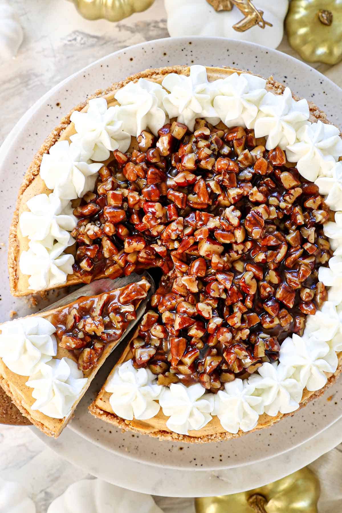 Showing how to make No Bake Pumpkin Cheesecake by topping with praline sauce