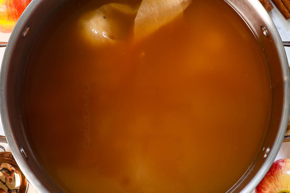 showing how to make wassail by simmering for 35 minutes with the spices