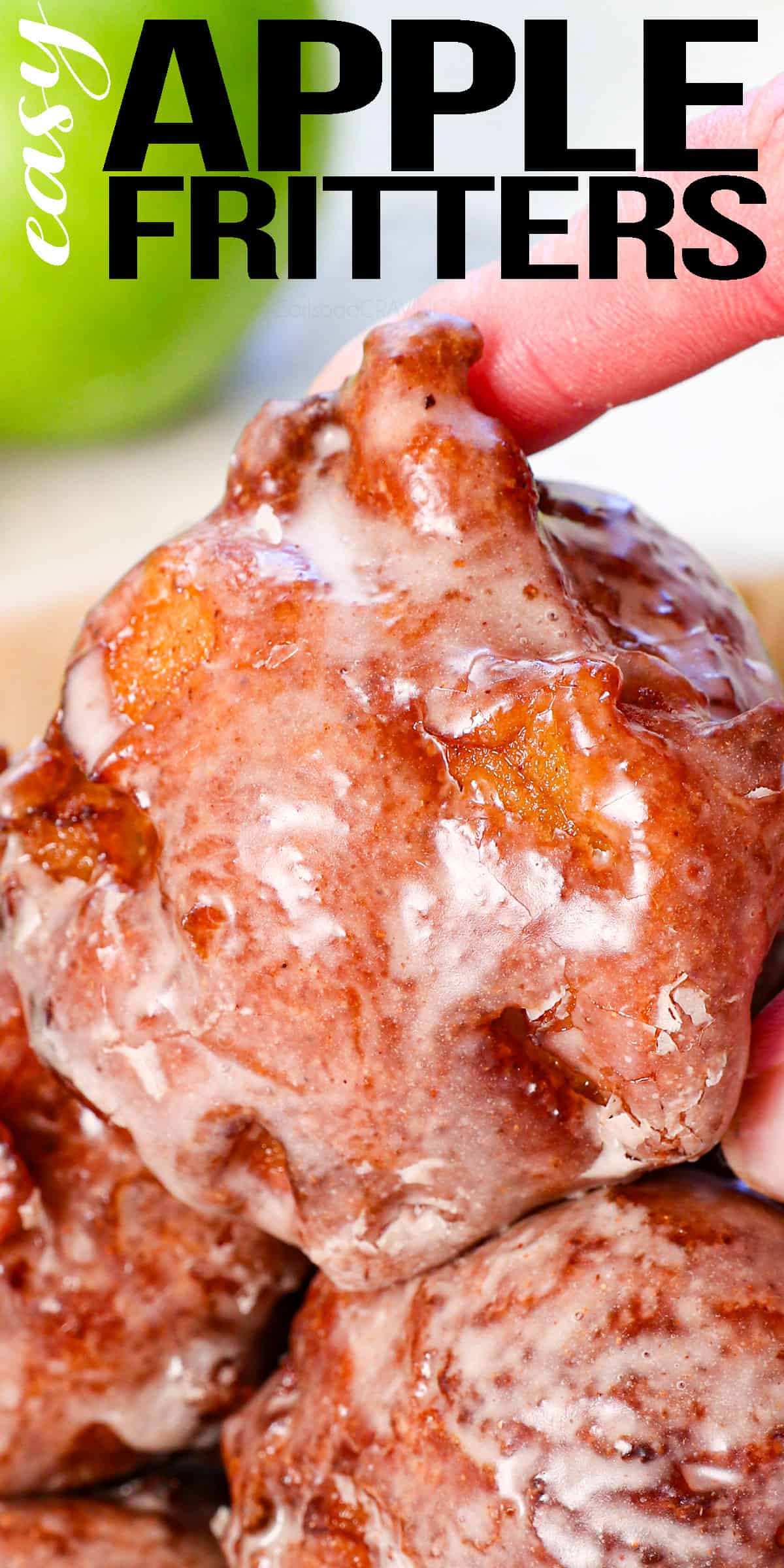 up close of holding an apple fritter showing the glazed outsdide