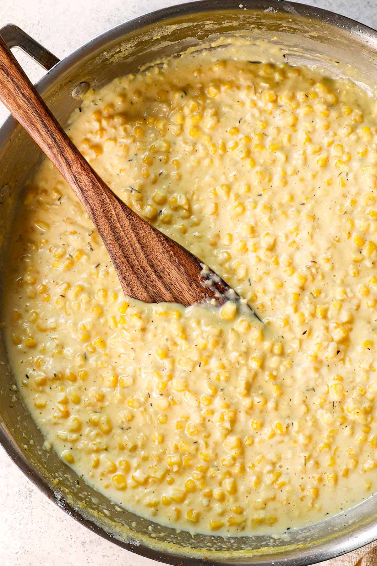 showing how to make creamed corn by adjusting the consistency to taste