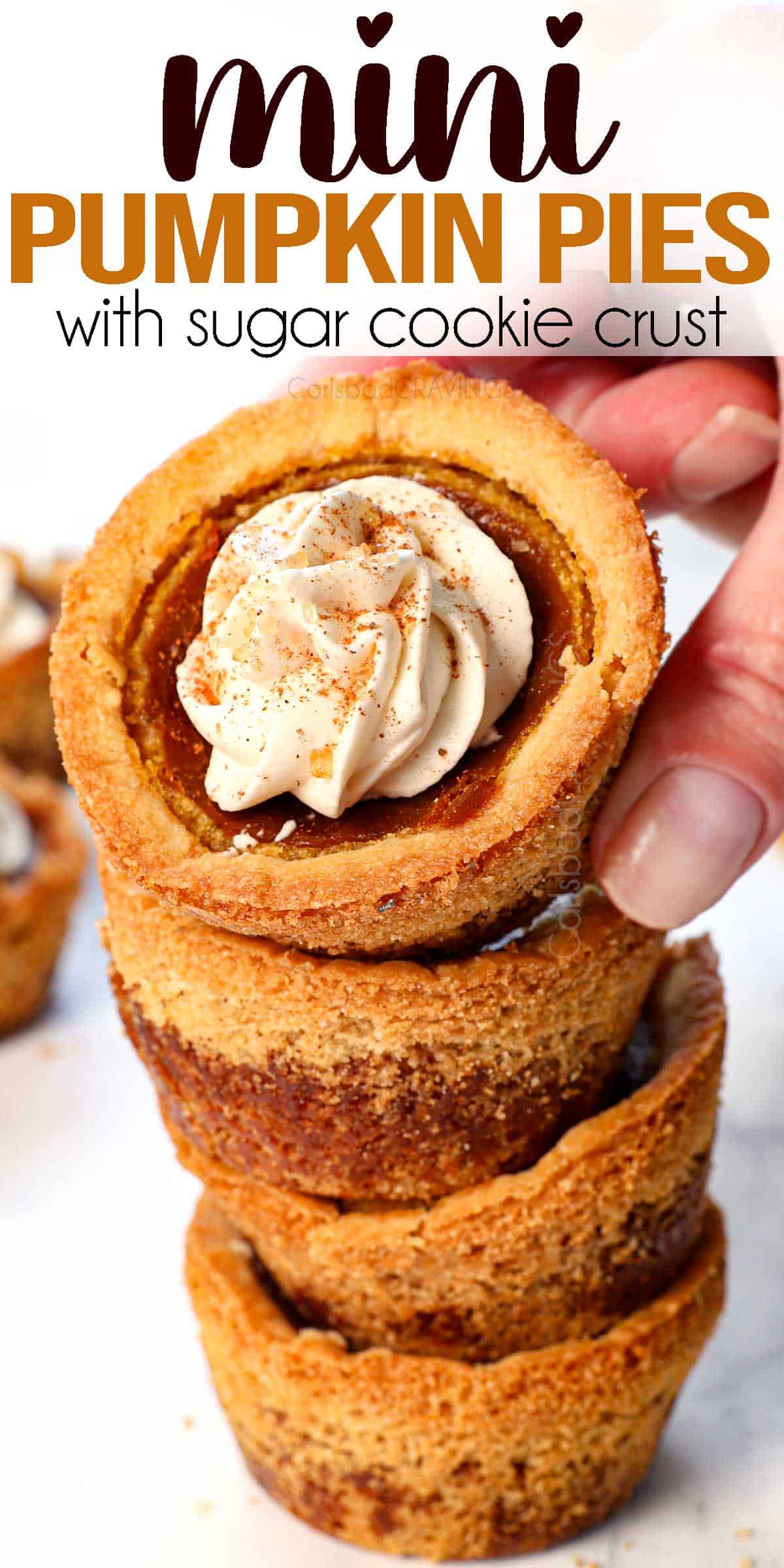 a stack of mini pumpkin pies with the top one tilted to see the whipped cream topping over the filling