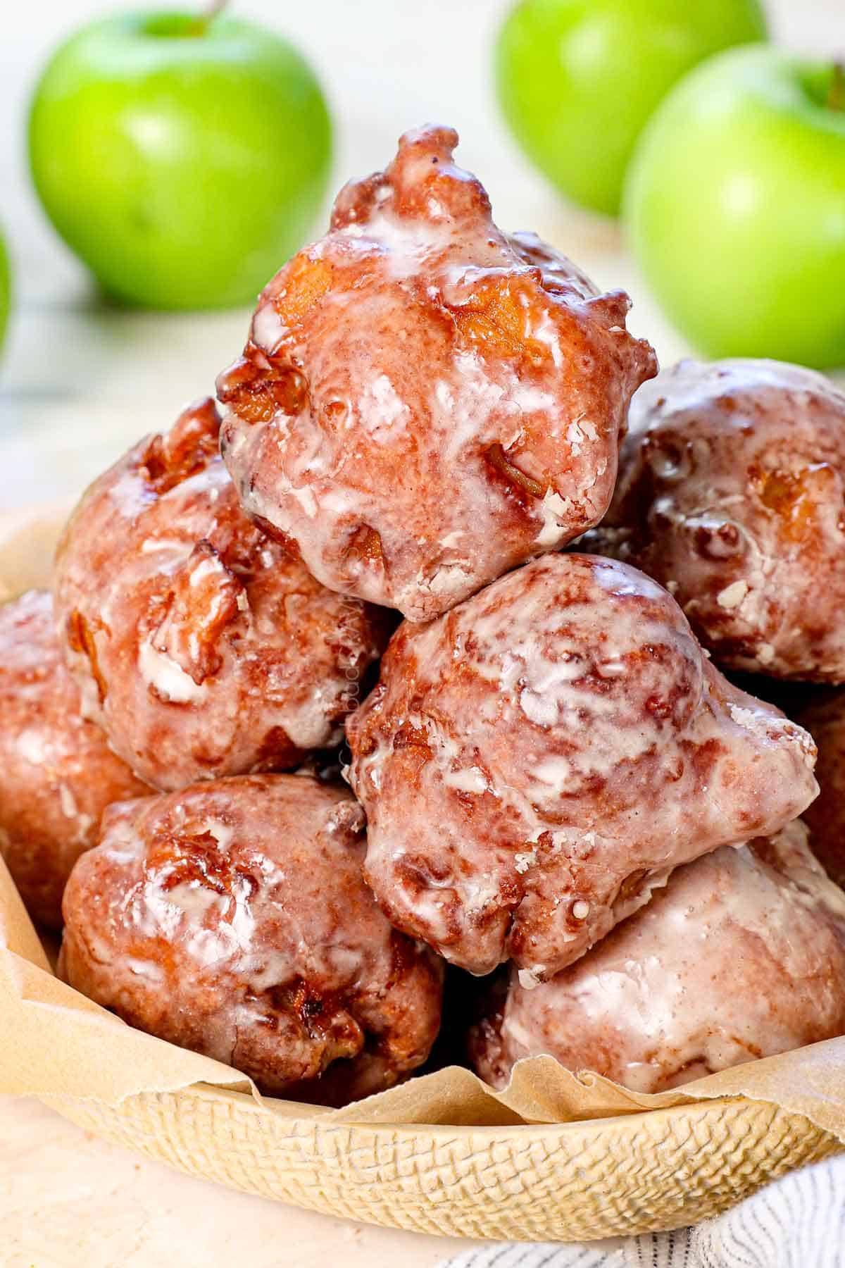 apple fritter recipe stacked on a platter with glaze