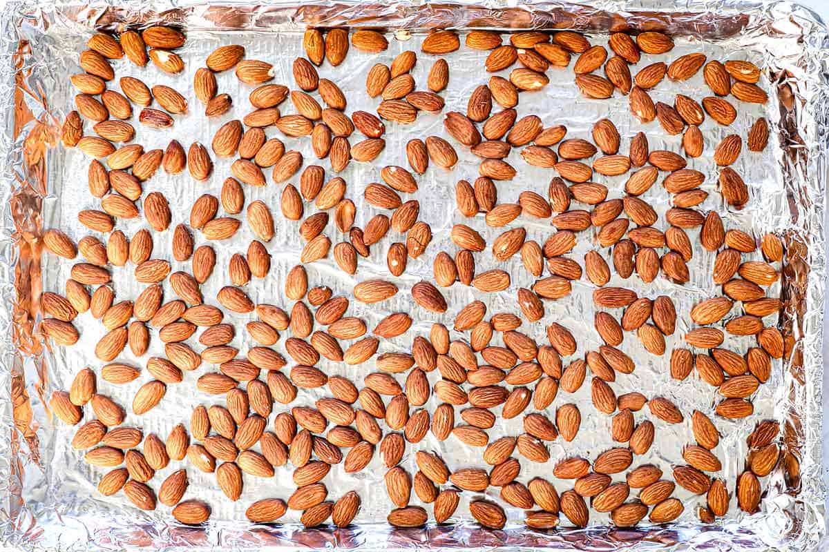 showing how to make almond roca by roasting the almonds in the oven