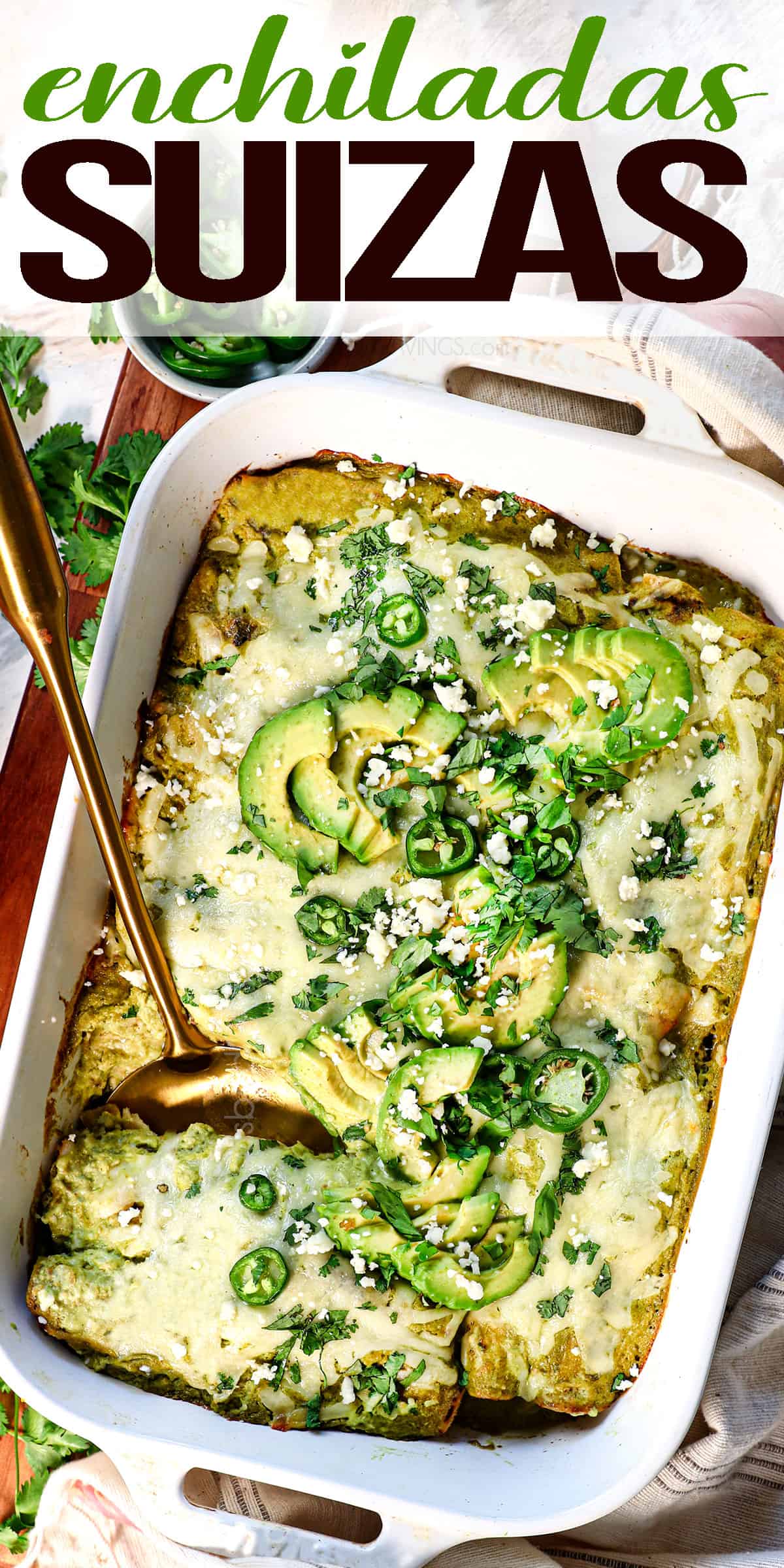 top view of enchiladas suizas topped with avocados, cilantro and jalapeños