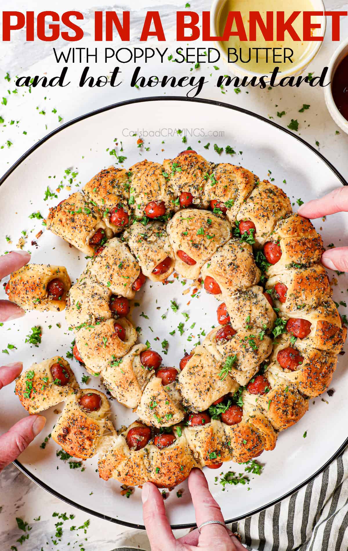 top view of pigs in a blanket being eaten with hands