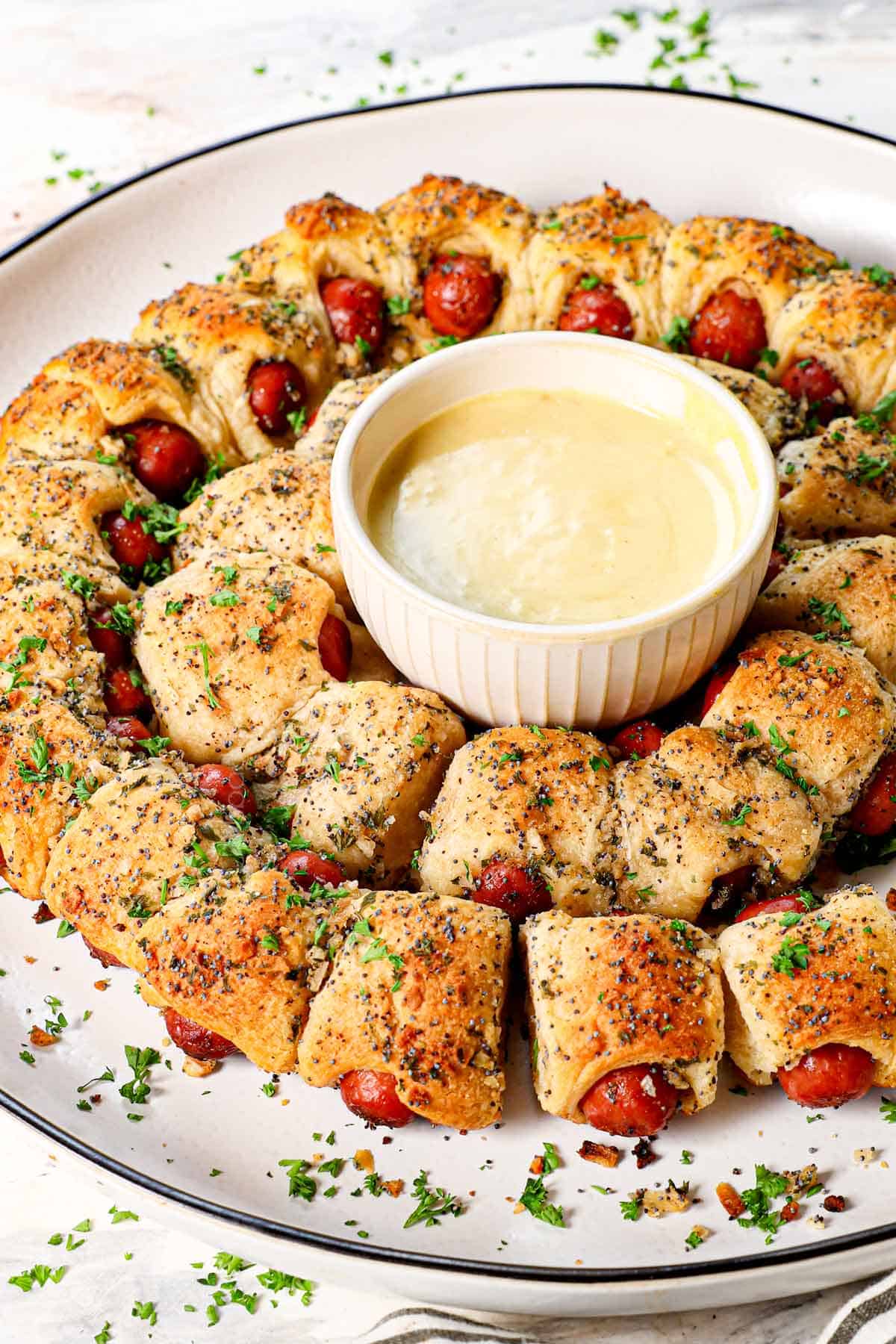 showing how to make pigs in a blanket by baking until the crescent rolls are golden