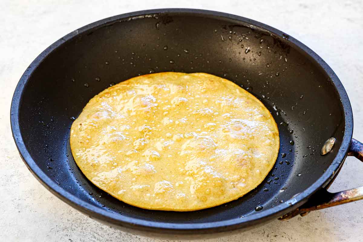 showing how to make Enchiladas Suizas by flash frying the tortillas a in a skillet